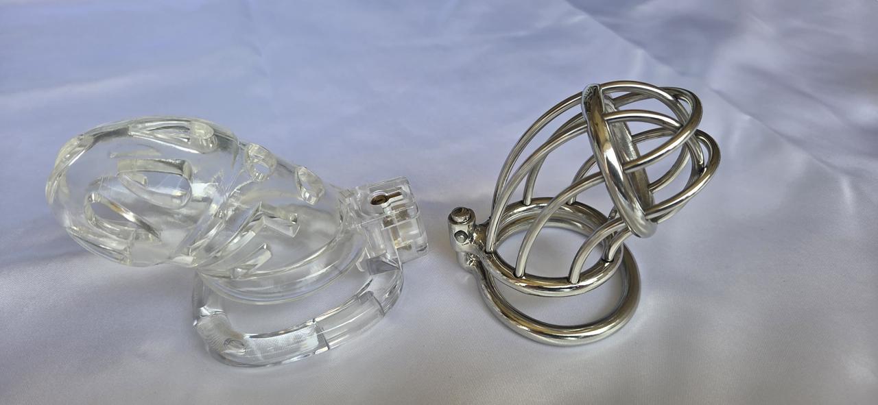 Clear plastic chastity cage beside a stainless steel open bar chastity cage.